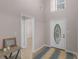 Welcoming foyer with high ceilings, decorative glass door, and view into adjoining rooms at 445 Royal St, Mcdonough, GA 30253