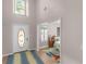 Bright foyer with high ceilings, decorative front door, and light hardwood floors leading to other rooms at 445 Royal St, Mcdonough, GA 30253