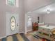 Welcoming entryway with a decorative glass door, neutral walls, and views into the dining room at 445 Royal St, Mcdonough, GA 30253
