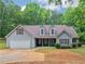 Charming single-Gathering home featuring a two-car garage, inviting front porch, and well-maintained landscaping at 445 Royal St, Mcdonough, GA 30253