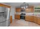 Kitchen area features stainless steel appliances, wood cabinetry, and ample counter space at 445 Royal St, Mcdonough, GA 30253
