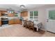 Eat-in kitchen features a table for 4, stainless steel appliances, and tile flooring at 445 Royal St, Mcdonough, GA 30253