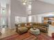 Open living room features vaulted ceilings and a large leather sectional sofa at 445 Royal St, Mcdonough, GA 30253