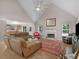 Open living room features vaulted ceilings, a fireplace, and access to the kitchen at 445 Royal St, Mcdonough, GA 30253