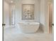 Luxurious bathroom with soaking tub, marble floors, and stylish fixtures creating a spa-like experience at 72 Homesite Cooper W Cv, Fayetteville, GA 30215