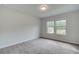 This bedroom features plush carpeting, two bright windows, and neutral paint at 72 Homesite Cooper W Cv, Fayetteville, GA 30215