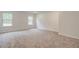 Large bedroom with neutral carpeting, natural lighting, and a serene atmosphere at 72 Homesite Cooper W Cv, Fayetteville, GA 30215