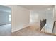 Upstairs hallway featuring neutral carpet flooring and a staircase with a dark metal banister at 72 Homesite Cooper W Cv, Fayetteville, GA 30215