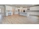 Modern kitchen featuring white cabinetry, stainless steel appliances, and a spacious center island at 72 Homesite Cooper W Cv, Fayetteville, GA 30215