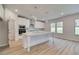 Bright kitchen with white cabinets, stainless steel appliances, and a large center island at 72 Homesite Cooper W Cv, Fayetteville, GA 30215
