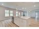Kitchen island with a stainless steel dishwasher and views of the living room at 72 Homesite Cooper W Cv, Fayetteville, GA 30215