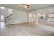 Bright open-concept living room flowing into a modern kitchen with hardwood flooring at 72 Homesite Cooper W Cv, Fayetteville, GA 30215