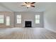 Spacious living room with a cozy fireplace, neutral tones, and hardwood flooring at 72 Homesite Cooper W Cv, Fayetteville, GA 30215