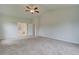 Large main bedroom with plush carpet, ensuite bathroom access, and bright, neutral paint at 72 Homesite Cooper W Cv, Fayetteville, GA 30215