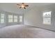 Spacious main bedroom with vaulted ceiling, cozy carpet, and plenty of natural light from multiple windows at 72 Homesite Cooper W Cv, Fayetteville, GA 30215