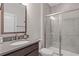 Modern bathroom featuring tile shower with glass door and vanity with sink at 830 Stone Ridge Ln, Atlanta, GA 30324
