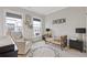 Bright Bedroom featuring two windows, a crib, rocker, and unique alphabet rug for a cozy and stylish space at 830 Stone Ridge Ln, Atlanta, GA 30324