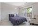 Cozy bedroom featuring a plush queen bed, accent chair, and lots of natural light at 830 Stone Ridge Ln, Atlanta, GA 30324