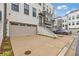 Close up of a luxury townhome with a 2-car garage and landscaped entry stairs at 830 Stone Ridge Ln, Atlanta, GA 30324
