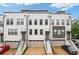 Modern townhomes boast a painted brick facade, individual garages, and inviting entry stairs at 830 Stone Ridge Ln, Atlanta, GA 30324