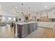 Open-concept kitchen with island, stainless appliances, hardwood floors, and adjacent dining and living areas at 830 Stone Ridge Ln, Atlanta, GA 30324
