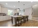 Bright kitchen featuring an island with bar seating, pendant lights, and stainless steel appliances at 830 Stone Ridge Ln, Atlanta, GA 30324