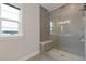 Contemporary shower featuring glass enclosure, sleek tile, and a built-in bench for a spa-like experience at 830 Stone Ridge Ln, Atlanta, GA 30324