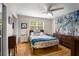 Bright bedroom featuring hardwood floors, ceiling fan, and ample natural light from the window at 1177 Church St # A, Decatur, GA 30030