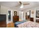 Cozy bedroom with light hardwood floors featuring ensuite bathroom and closet with mirror doors at 1177 Church St # A, Decatur, GA 30030