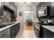 Modern kitchen featuring stainless steel appliances, tile backsplash, and a view into the dining room at 1177 Church St # A, Decatur, GA 30030