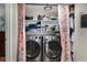 Convenient laundry area with modern washer and dryer, storage, and privacy curtain at 1177 Church St # A, Decatur, GA 30030