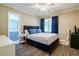 Bedroom with neutral colors, natural light, and sleek ceiling fan at 1420 Hillside Se Pl, Conyers, GA 30094
