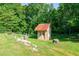 Charming shed in a green grassy yard surrounded by tall trees providing a backyard view at 1420 Hillside Se Pl, Conyers, GA 30094