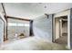 Unfinished basement with concrete floors and block walls with a garage door in disrepair at 2564 Riggs Dr, East Point, GA 30344