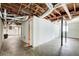 Large unfinished basement showing exposed ductwork, concrete floors, and support beams at 2564 Riggs Dr, East Point, GA 30344