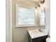 Cozy bathroom featuring a vanity, a large mirror, and a window bringing in natural light, creating a serene atmosphere at 2564 Riggs Dr, East Point, GA 30344