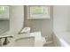 Cozy bathroom featuring marble countertop and a window view at 2564 Riggs Dr, East Point, GA 30344