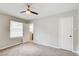 Bright bedroom featuring soft carpeting, ceiling fan, and a door that leads to an adjacent room, enhancing its functionality at 2564 Riggs Dr, East Point, GA 30344