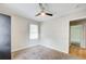 Bedroom with a ceiling fan, carpet, and a window to let in natural light at 2564 Riggs Dr, East Point, GA 30344