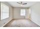 Cozy bedroom with plush carpeting, a ceiling fan, and natural light streaming through windows, creating a serene retreat at 2564 Riggs Dr, East Point, GA 30344