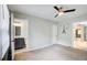 This bedroom features carpet, a ceiling fan, and an attached bathroom with a gray vanity and tiled floor at 2564 Riggs Dr, East Point, GA 30344