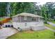 Two-story home with gray brick and landscaped lawn at 2564 Riggs Dr, East Point, GA 30344