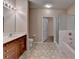 Bright bathroom with double sinks, wood cabinets, and a combination shower and bathtub at 3500 Sweetwater Rd # 522, Duluth, GA 30096