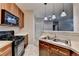 Open-concept kitchen with stainless steel sink, black appliances, and view to living area at 3500 Sweetwater Rd # 522, Duluth, GA 30096