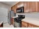 Well-lit kitchen featuring a black range, microwave, stainless fridge, and ample cabinet space at 3500 Sweetwater Rd # 522, Duluth, GA 30096