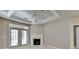 Bright living room with fireplace, French doors to a balcony, and trey ceiling at 3500 Sweetwater Rd # 522, Duluth, GA 30096