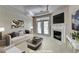 Staged living room featuring a fireplace, couch, and a decorative tray ceiling at 3500 Sweetwater Rd # 522, Duluth, GA 30096