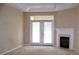 Bright living room with a fireplace and double doors leading to the outside at 3500 Sweetwater Rd # 522, Duluth, GA 30096