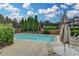 Community pool with lounge chairs, greenery, and a sunny sky at 3500 Sweetwater Rd # 522, Duluth, GA 30096