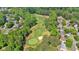 Beautiful aerial view of a scenic golf course community with lush green fairways and mature trees at 4012 Ironhill Ln, Woodstock, GA 30189